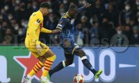 Barcellona's Uruguayan defender Ronald Araujo challenges for the ball with SSC Napoli's Senegalese defender Kalidou Koulibaly during the UEFA Europa League football match between SSC Napoli and Barcellona at the Diego Armando Maradona Stadium in Naples, southern Italy, on February 24, 2022.